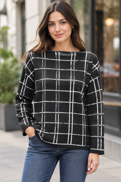 Female model wearing the black long-sleeve plaid sweater