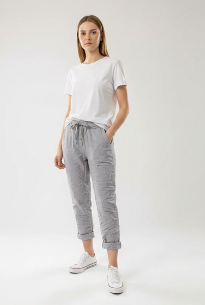Grey drawstring pants on a female model