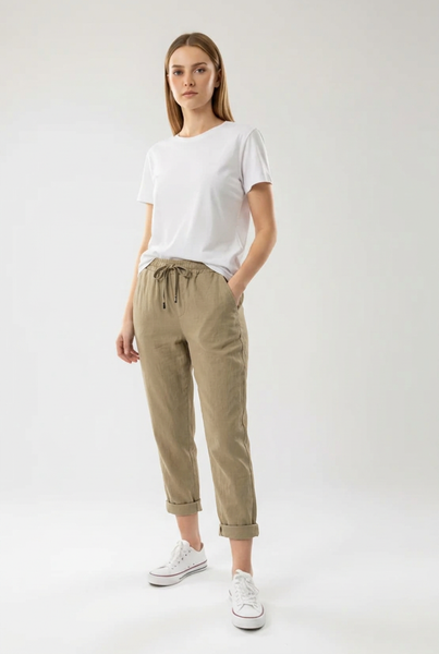 Khaki drawstring pants on a female model