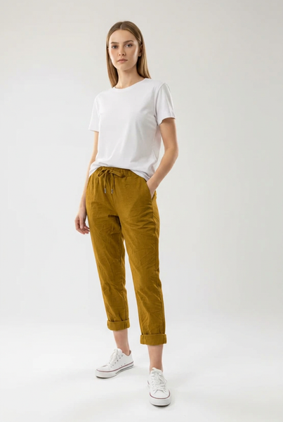 Mustard drawstring pants on a female model