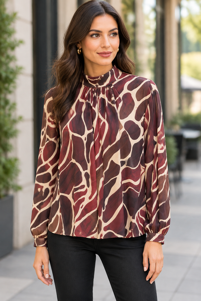 Female model wearing the wine blouse shown in the first product media photo