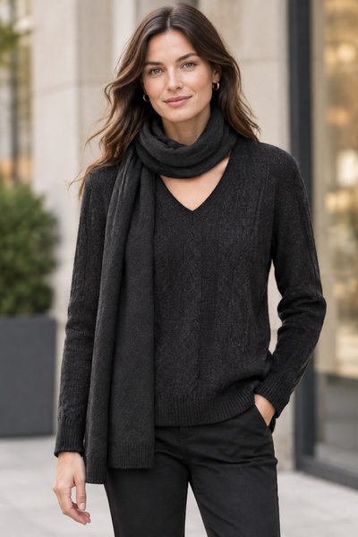 Female model wearing the black long-sleeve sweater with its matching scarf
