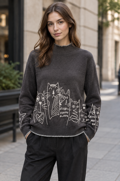 Female model wearing the beige long-sleeve cat-print sweater