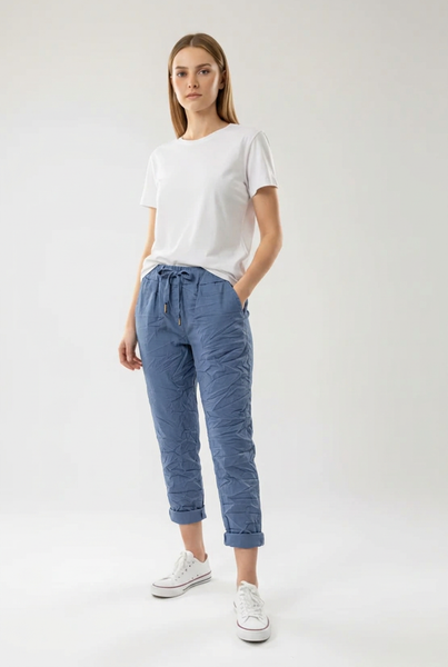 Denim blue drawstring pants on a female model