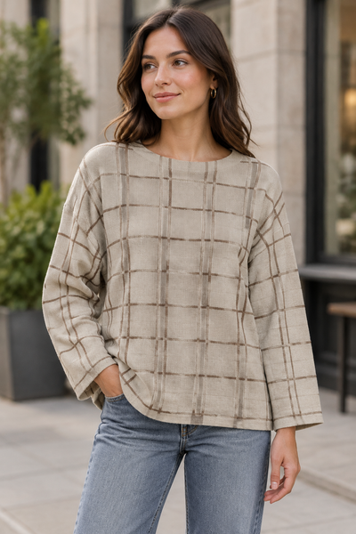 Female model wearing the beige long-sleeve plaid sweater