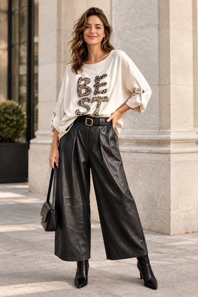 Female model wearing the black belted vegan leather gaucho at the same style and length as the first photo