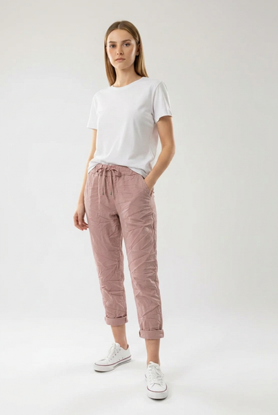 Dusty pink drawstring pants on a female model