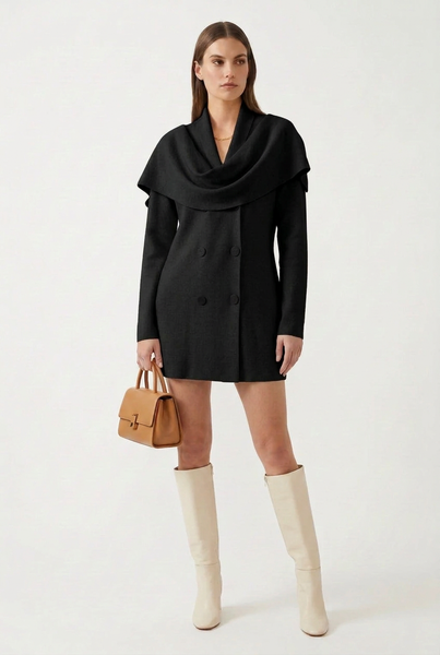 Black draped shawl collar sweater tunic on a female model with ivory knee-high boots and a tan handbag