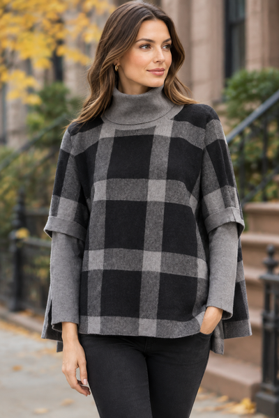 Grey plaid poncho sweater on a female model