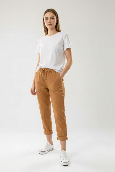 Camel drawstring pants on a female model